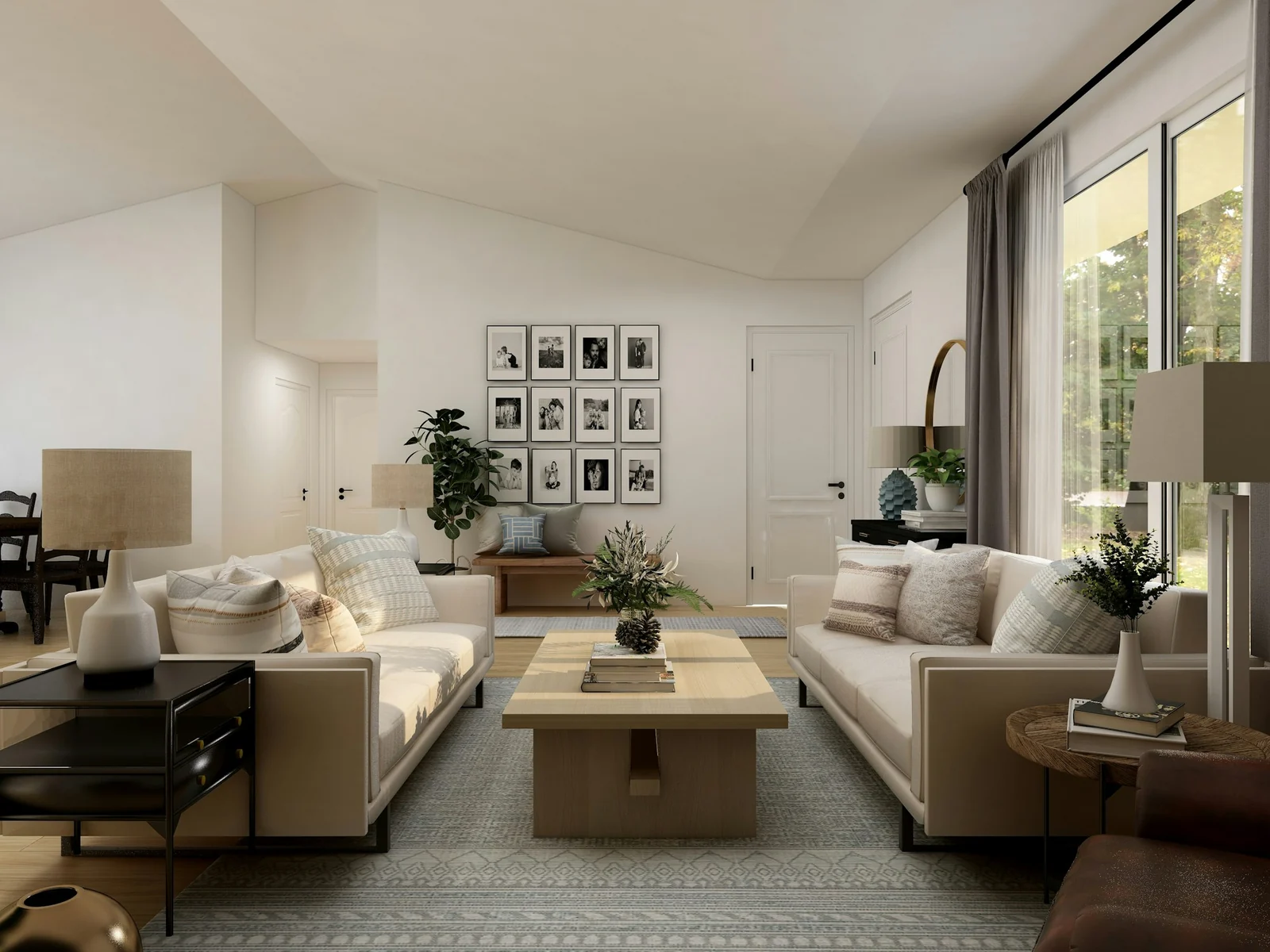 Open living room with two cream sofas facing a coffee table and a framed photo wall